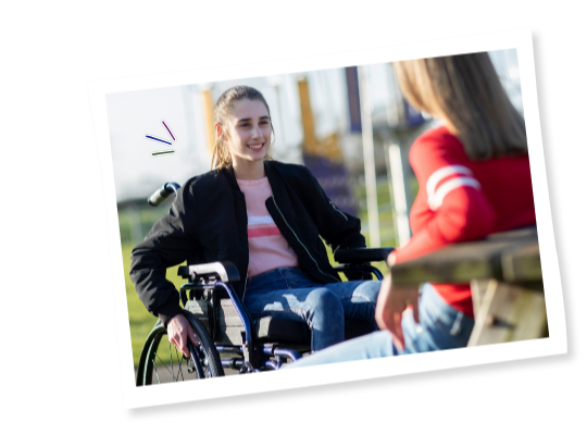 Young people in wheelchairs talking outside